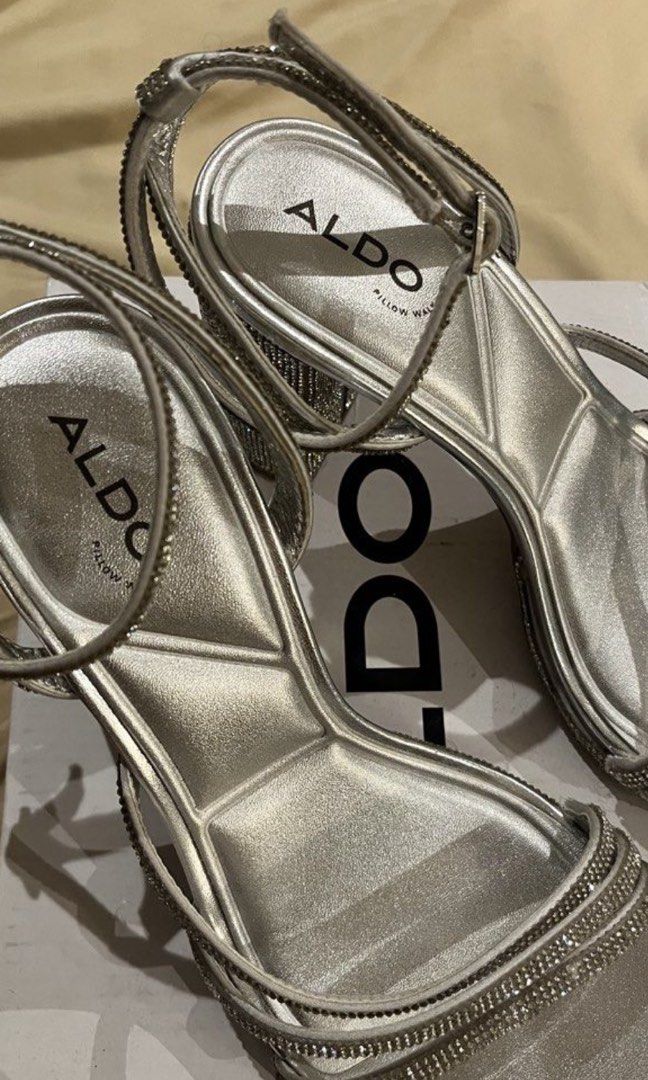 ALDO Silver Rhinestone Block Heels (Category: Heels) located in Las Pinas. Submitted by francesaly (Listing ID 1466316499, Image 3). Description: - Brand: ALDO - Style: Silver rhinestone block heels with a strappy front design - Features: Adjustable ankle strap and fully rhinestone-covered block heel for extra sparkle - Inclusion: Original box included.