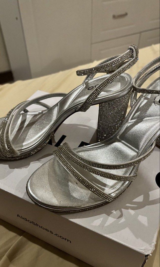 ALDO Silver Rhinestone Block Heels (Category: Heels) located in Las Pinas. Submitted by francesaly (Listing ID 1466316499, Image 2). Description: - Brand: ALDO - Style: Silver rhinestone block heels with a strappy front design - Features: Adjustable ankle strap and fully rhinestone-covered block heel for extra sparkle - Inclusion: Original box included.