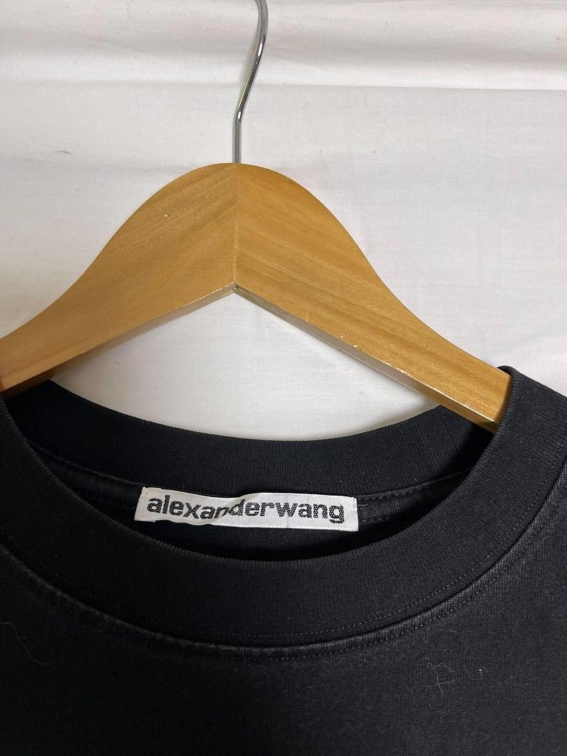 Alexander Wang Black Graphic T-Shirt (Category: Shirts) located in Manila. Submitted by japee55 (Listing ID 1466270418, Image 2). Description: - Brand: Alexander Wang - Color: Solid black with contrast white logo - Size: Medium (100% cotton) - Design: Repeated logo graphic on the chest with classic ribbed crewneck - Condition: Great casual everyday piece, ready to wear.