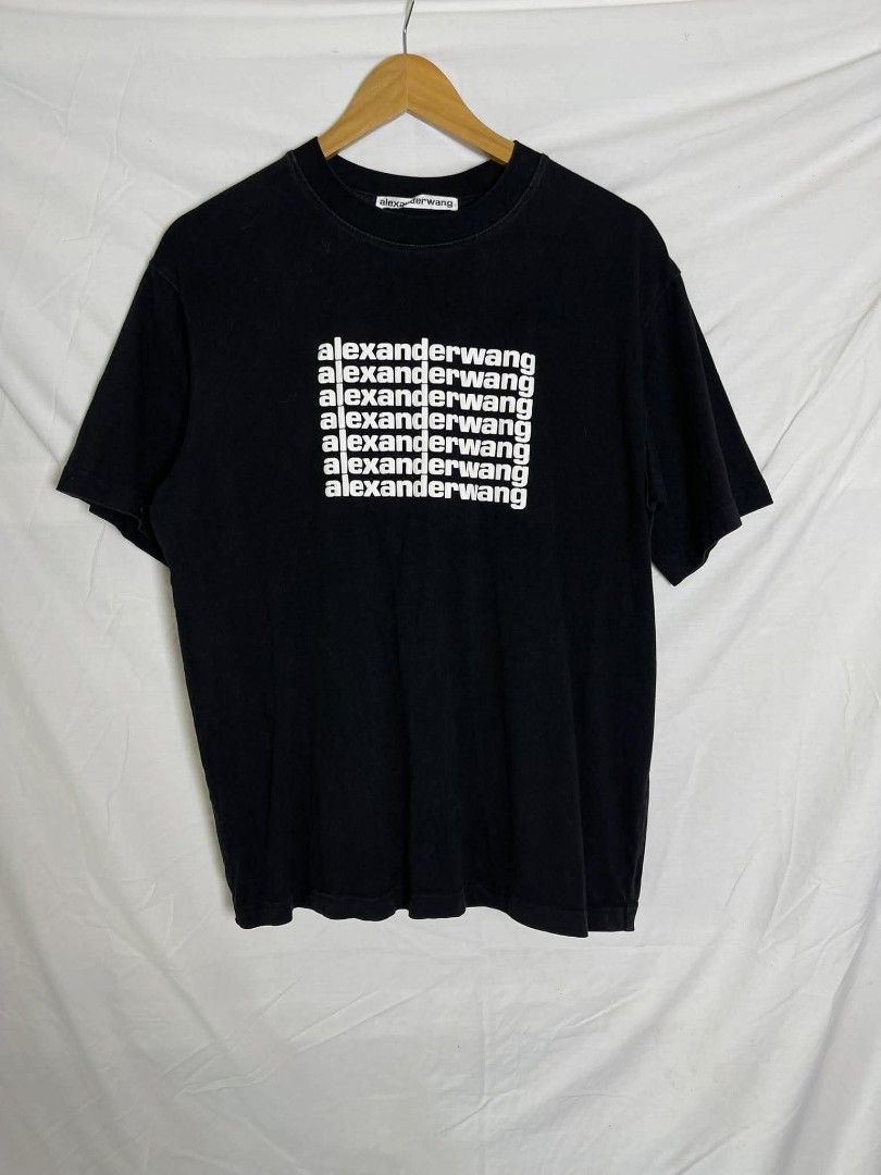 Alexander Wang Black Graphic T-Shirt (Category: Shirts) located in Manila. Submitted by japee55 (Listing ID 1466270418, Image 1). Description: - Brand: Alexander Wang - Color: Solid black with contrast white logo - Size: Medium (100% cotton) - Design: Repeated logo graphic on the chest with classic ribbed crewneck - Condition: Great casual everyday piece, ready to wear.