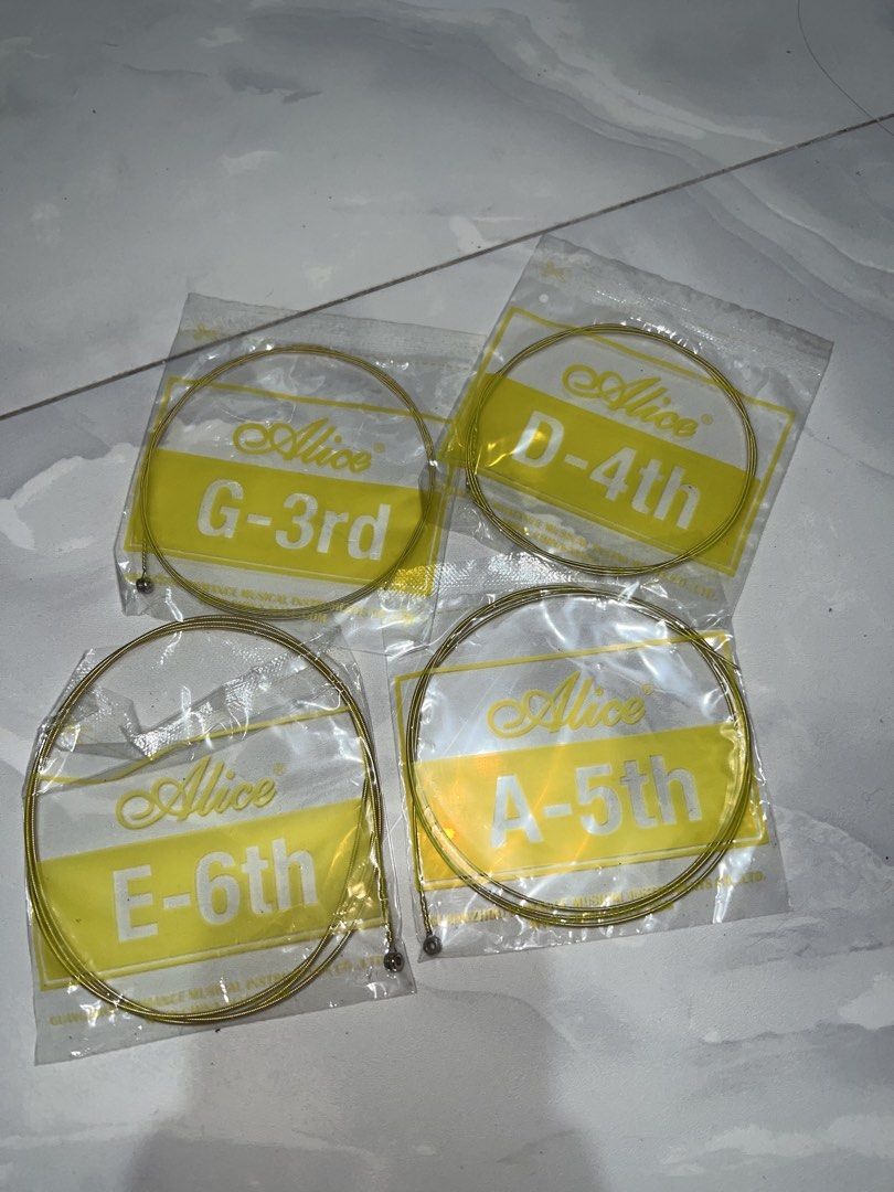 Alice Acoustic Guitar Strings Set G-3rd D-4th A-5th E-6th (Category: Musical Instruments) located in Marikina City. Submitted by ash_2 (Listing ID 1466198574, Image 1). Description: - Brand: Alice - Included Strings: G-3rd, D-4th, A-5th, and E-6th - Condition: Brand new, sealed in original yellow packaging - Ideal Use: Great backup set to replace worn or broken lower strings -50 each.