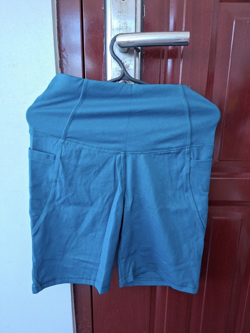 ALL IN MOTION HIGH RISE SHORT WITH POCKETS (Category: Activewear) located in Abucay. Submitted by petiteprettyboutiquev2 (Listing ID 1466180555, Image 1). Description: High-waisted athletic biker shorts in a dark teal or blue-green shade featuring convenient side pockets + SF(J&T).