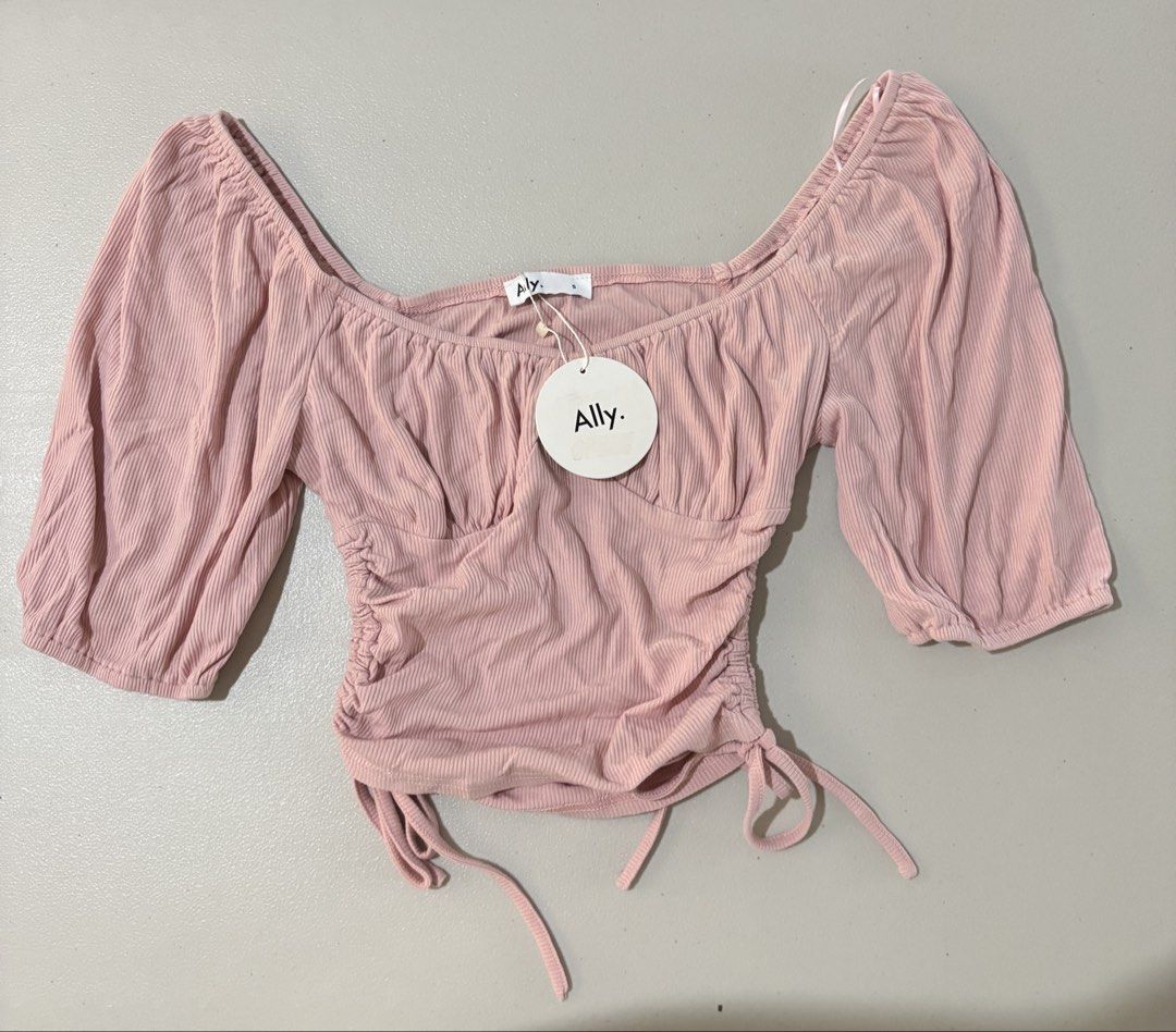 Ally Pink Ribbed Off-Shoulder Top (Category: Sleeveless) located in Guimba. Submitted by huenited (Listing ID 1466218115, Image 1). Description: - Brand: Ally - Condition: Brand new with tags (BNWT) - Size: Small - Color: Pink - Details: Ribbed fabric, square neckline, ruched front, short puff sleeves, and adjustable side drawstrings.