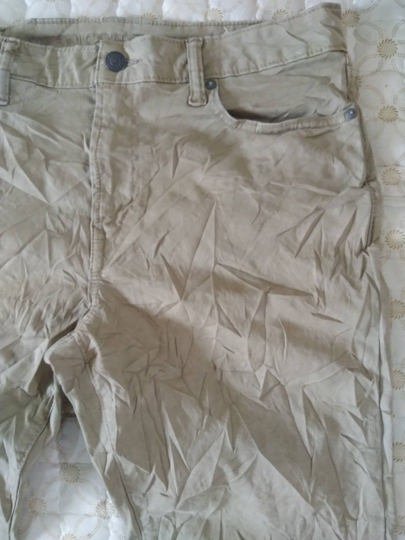 American Eagle Beige Khaki Pants Trousers (Category: Chinos) located in Zamboanga. Submitted by nurbya898048 (Listing ID 1466259619, Image 2). Description: - Brand: American Eagle - Style: Classic five-pocket khaki trousers - Color: Neutral beige - Details: Button closure, belt loops, and leather brand patch on the back waistband - Condition: Good, but needs a quick iron due to storage wrinkles - Versatility: Easy to pair with both t-shirts and b