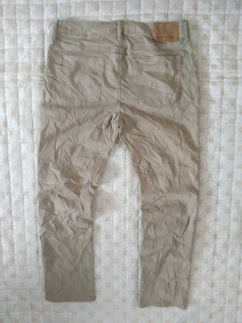 American Eagle Beige Khaki Pants Trousers (Category: Chinos) located in Zamboanga. Submitted by nurbya898048 (Listing ID 1466259619, Image 3). Description: - Brand: American Eagle - Style: Classic five-pocket khaki trousers - Color: Neutral beige - Details: Button closure, belt loops, and leather brand patch on the back waistband - Condition: Good, but needs a quick iron due to storage wrinkles - Versatility: Easy to pair with both t-shirts and b