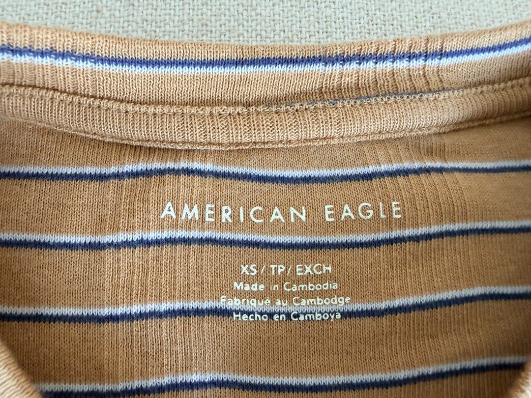 American Eagle Striped Ribbed T-Shirt (Category: Shirts) located in Quezon City. Submitted by makingroomfinds (Listing ID 1466182719, Image 3). Description: - Brand: American Eagle - Style: Short sleeve crewneck tee with ribbed texture - Colorway: Brown, white, and navy horizontal stripes - Size: XS (inner tag) - Condition: Brand new with sticker attached.