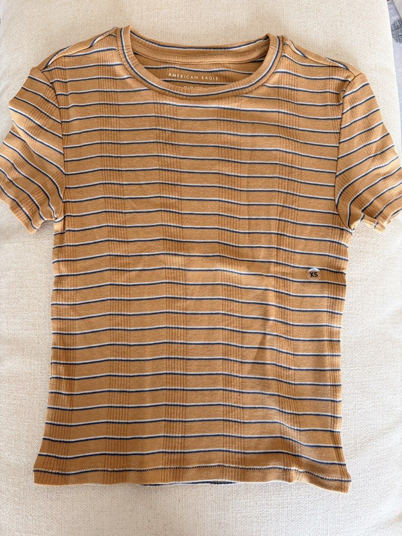 American Eagle Striped Ribbed T-Shirt (Category: Shirts) located in Quezon City. Submitted by makingroomfinds (Listing ID 1466182719, Image 1). Description: - Brand: American Eagle - Style: Short sleeve crewneck tee with ribbed texture - Colorway: Brown, white, and navy horizontal stripes - Size: XS (inner tag) - Condition: Brand new with sticker attached.