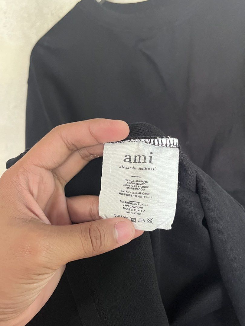 AMI Black Plain Shirt (Category: Luxury Apparel) located in Adams. Submitted by princess.maggie (Listing ID 1466166576, Image 2). Description: - large on tag - 23 x 27 - in good condition - issue: cut main tag and slight oil stain only - color may vary due to lighting pero super itim pa po nito.