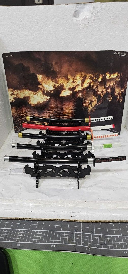 Anime Miniature Katana Sword Set with Stand (Category: Figurines & Statues) located in Baguio. Submitted by bitsbaguio (Listing ID 1466199621, Image 1). Description: - miniature katana sword with display stand and scabbard for desktop display or 1/6 kitbash - diecast blade - price for each. Random design will be sent for delivery. - figure not included [used as reference only] - as-is. wysiwyg.