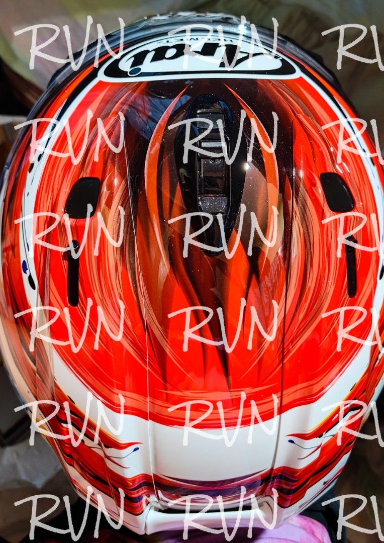 Arai RX-7X Nagashima Graphic Helmet (Category: Travel Essentials & Accessories) located in Valenzuela. Submitted by agentrvn (Listing ID 1466160650, Image 2). Description: - Brand/Model: Arai RX-7X Full Face Helmet - Design: Vibrant Nagashima graphic with white base, red, blue, yellow accents, and a playful dog illustration on the back - Size: XL (61-62cm) - Inclusions: Original manual, care products, and accessories as seen in photos - Condition