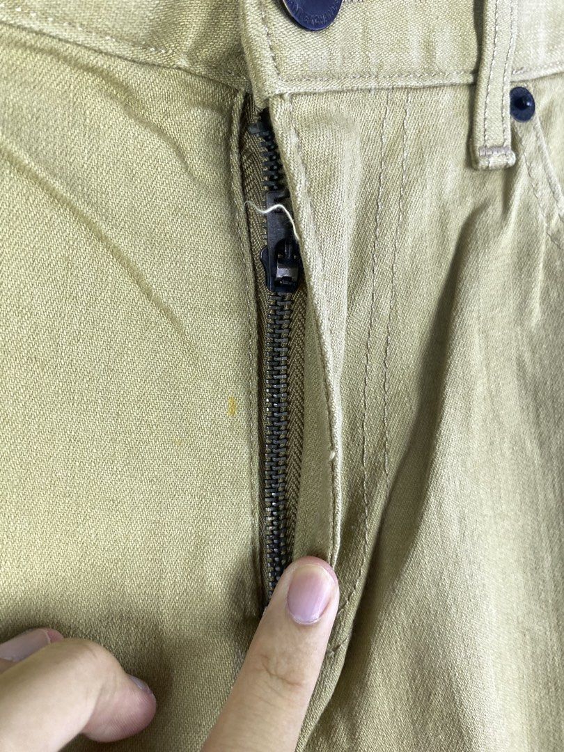 Armani Exchange Khaki Pants Size 32 (Category: Trousers) located in Manila. Submitted by declutterpromax (Listing ID 1466214036, Image 2). Description: - Brand: Armani Exchange - Size: 32 - Color: Versatile khaki / earth tone - Fit: Straight leg - Style: Classic five-pocket styling with zipper fly and button closure - Details: Branded label patch on the back waistband - Origin: Made in India.