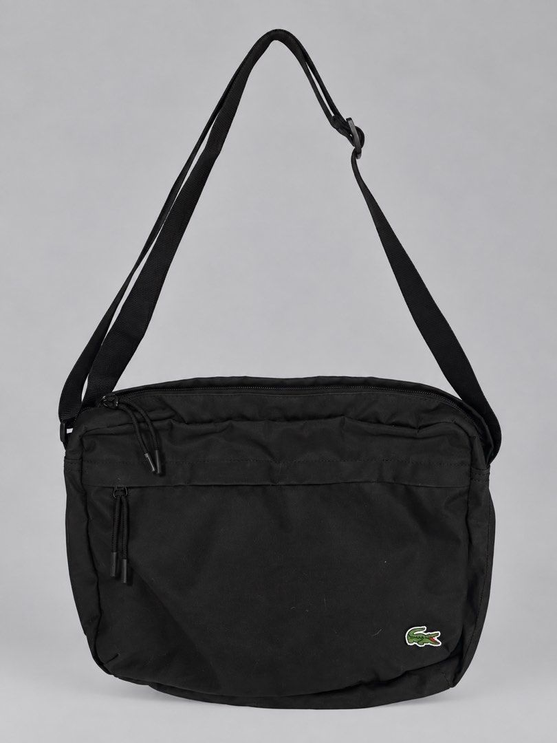 Authentic Lacoste Shoulder Sling Crossbody Bag (Black) (Category: Sling Bags) located in Manila. Submitted by socalkid (Listing ID 1466238317, Image 1). Description: Lacoste Shoulder Sling Crossbody Bag (Black) Spacious capacity with multiple internal pockets for excellent functionality, can fit an 11-in laptop comfortably. Adjustable strap. Dimensions: Length - 13.5’ Height - 9.5’ ✅ No functional issue, minimal signs of usage, minor hairline scr