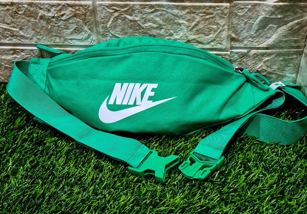 Authentic Nike Heritage Waistpack (Category: Belt bags, Clutches and Pouches) located in Antipolo. Submitted by saribymonica (Listing ID 1466163443, Image 1). Description: green Nike Heritage Waistpack featuring a prominent white Nike Swoosh logo on the front canvas compartment and an adjustable strap with a snap buckle. “As-is. No returns, refunds, or exchanges. Please see photos for the actual condition and details.”.