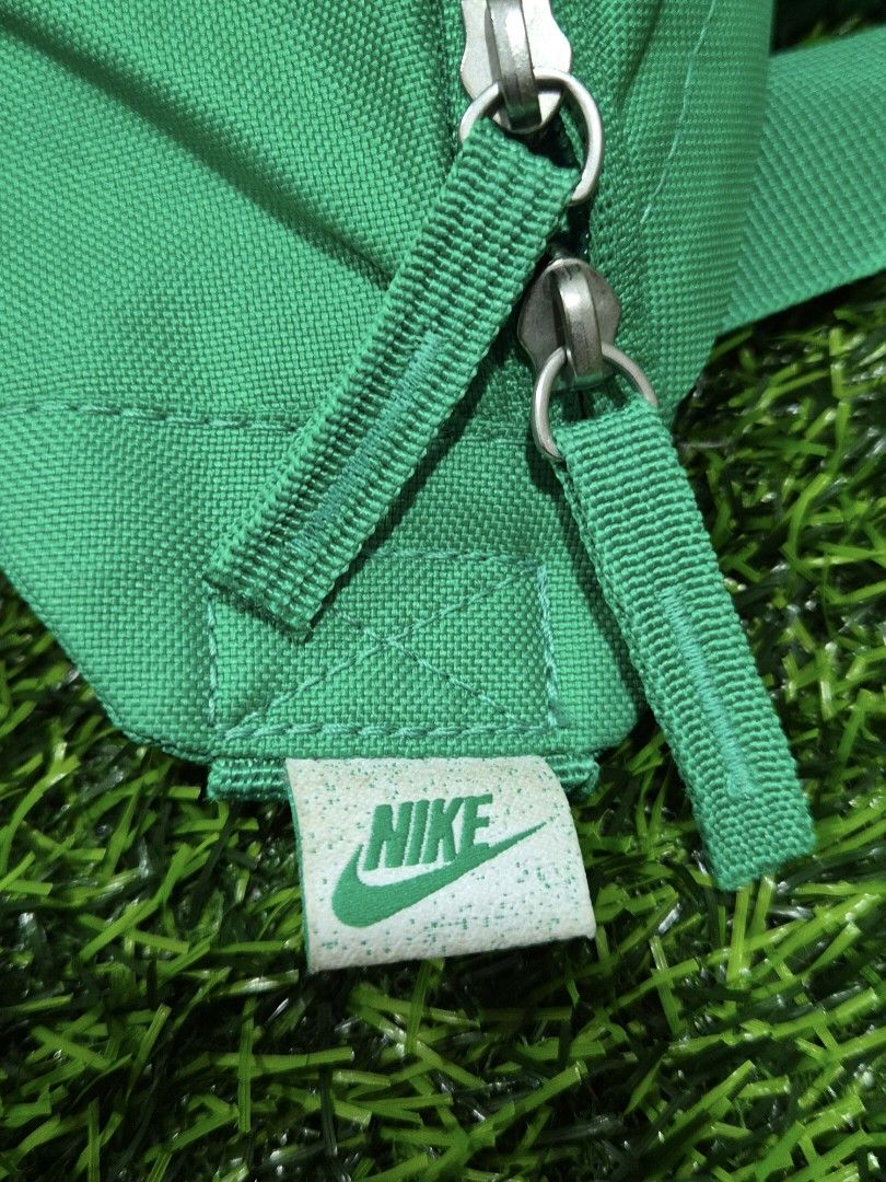 Authentic Nike Heritage Waistpack (Category: Belt bags, Clutches and Pouches) located in Antipolo. Submitted by saribymonica (Listing ID 1466163443, Image 3). Description: green Nike Heritage Waistpack featuring a prominent white Nike Swoosh logo on the front canvas compartment and an adjustable strap with a snap buckle. “As-is. No returns, refunds, or exchanges. Please see photos for the actual condition and details.”.
