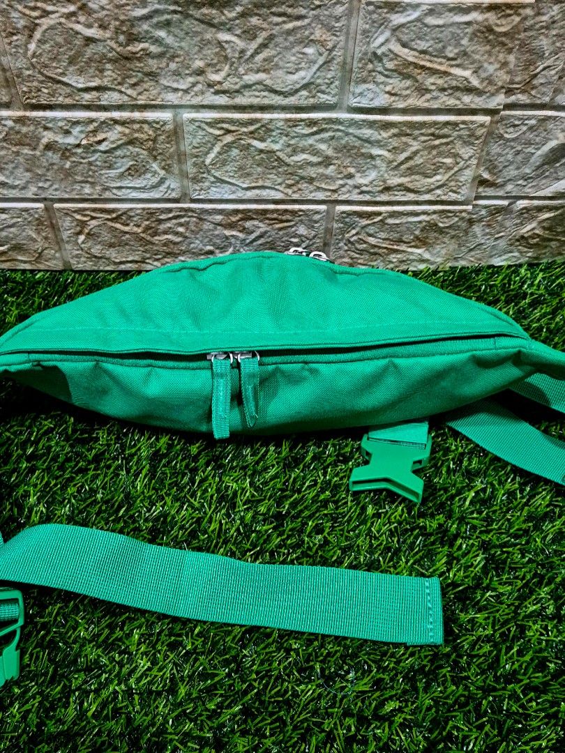 Authentic Nike Heritage Waistpack (Category: Belt bags, Clutches and Pouches) located in Antipolo. Submitted by saribymonica (Listing ID 1466163443, Image 2). Description: green Nike Heritage Waistpack featuring a prominent white Nike Swoosh logo on the front canvas compartment and an adjustable strap with a snap buckle. “As-is. No returns, refunds, or exchanges. Please see photos for the actual condition and details.”.