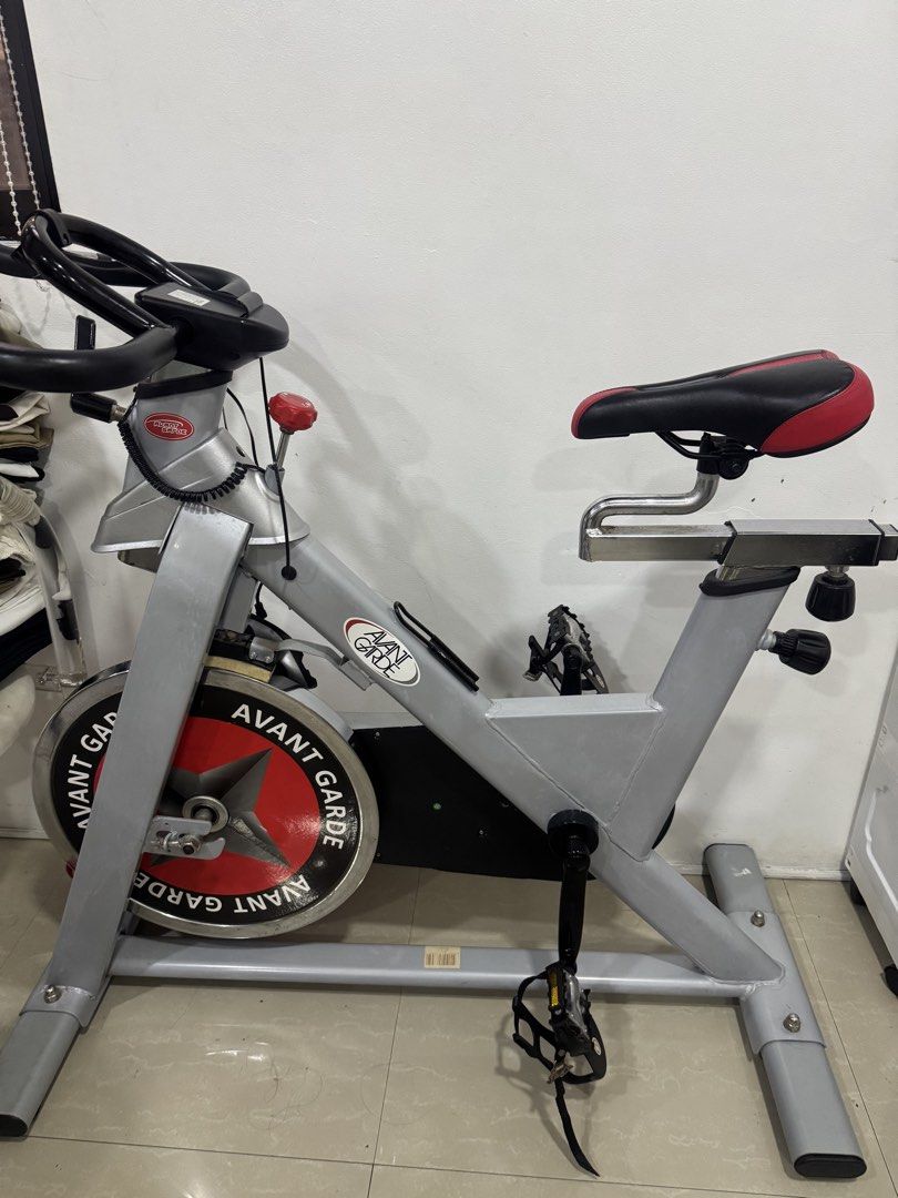 Avant Garde Indoor Exercise Bike (Category: Cardio & Fitness Machines) located in Manila. Submitted by sharry24 (Listing ID 1466157117, Image 1). Description: - Brand: Avant Garde indoor stationary bike - Heavy front flywheel with striking red and black graphic plate - Adjustable handlebars with built-in device holder and easy-reach resistance knob - Comfortable padded black and red seat on a chrome slider - Secure pedals featuring toe cages and 