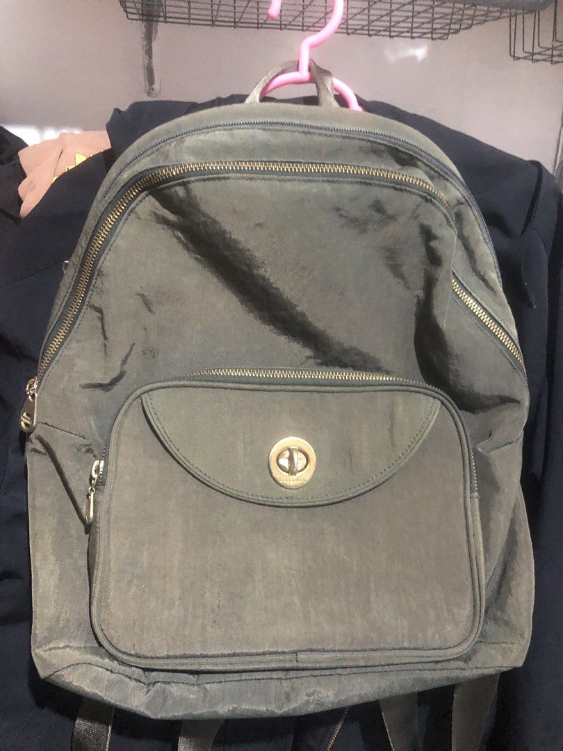 Baggallini Olive Green Nylon Backpack with Twist Lock (Category: Backpacks) located in Manila. Submitted by rshay (Listing ID 1466281925, Image 1). Description: - Brand: Baggallini - Color: Olive green with light grey branded interior lining - Material: Lightweight durable nylon - Closure: Gold twist-lock front pocket and secure zippered main compartment - Storage: Includes interior slip pockets and a zippered pocket - Comfort: Adjustable shoulde