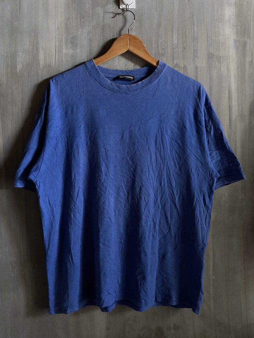 Balenciaga Back Logo Tee Blue Size S (Category: Luxury Apparel) located in M'Lang. Submitted by thrift_finds2 (Listing ID 1466176919, Image 2). Description: - Brand: Balenciaga - Color: Blue with large white lettering on back shoulders - Size: S (Relaxed fit) - Design: Classic crew neck, short sleeves, black inner collar label - Origin: Made in Portugal - Style: Ultimate streetwear staple.