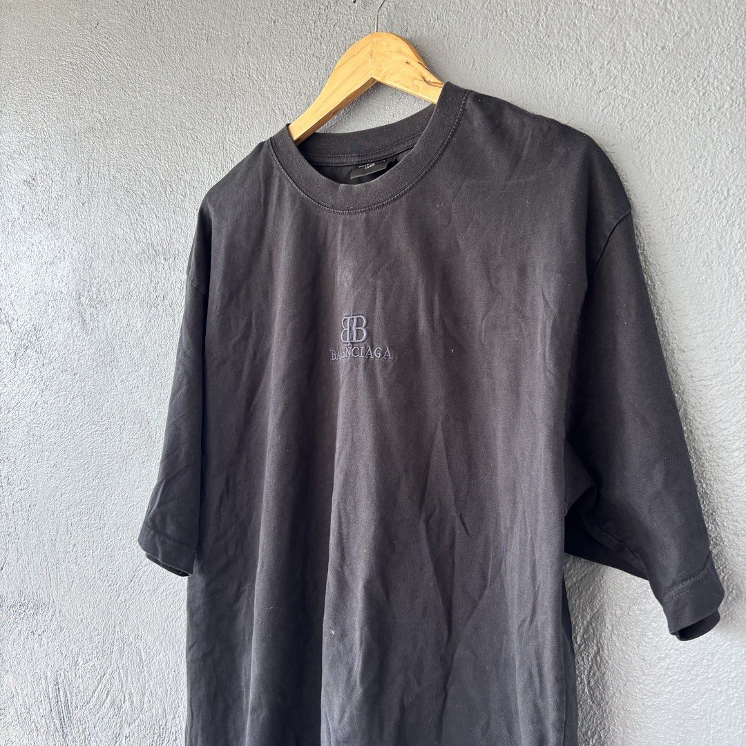 Balenciaga distressed tee (Category: Tshirts & Polo Shirts ) located in San Fernando. Submitted by diff.thr1ft (Listing ID 1466170454, Image 2). Description: - Brand: Balenciaga - Color: Black - Size: L (Unisex) - Material: High-quality cotton - Design: Distressed raw-edge hem with hanging threads, embroidered BB logo on the chest - Origin: Made in Portugal - Condition: Excellent pre-owned condition with intentional factory distressing.