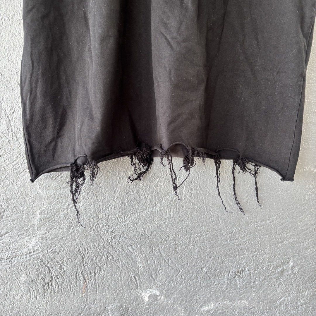 Balenciaga distressed tee (Category: Tshirts & Polo Shirts ) located in San Fernando. Submitted by diff.thr1ft (Listing ID 1466170454, Image 3). Description: - Brand: Balenciaga - Color: Black - Size: L (Unisex) - Material: High-quality cotton - Design: Distressed raw-edge hem with hanging threads, embroidered BB logo on the chest - Origin: Made in Portugal - Condition: Excellent pre-owned condition with intentional factory distressing.