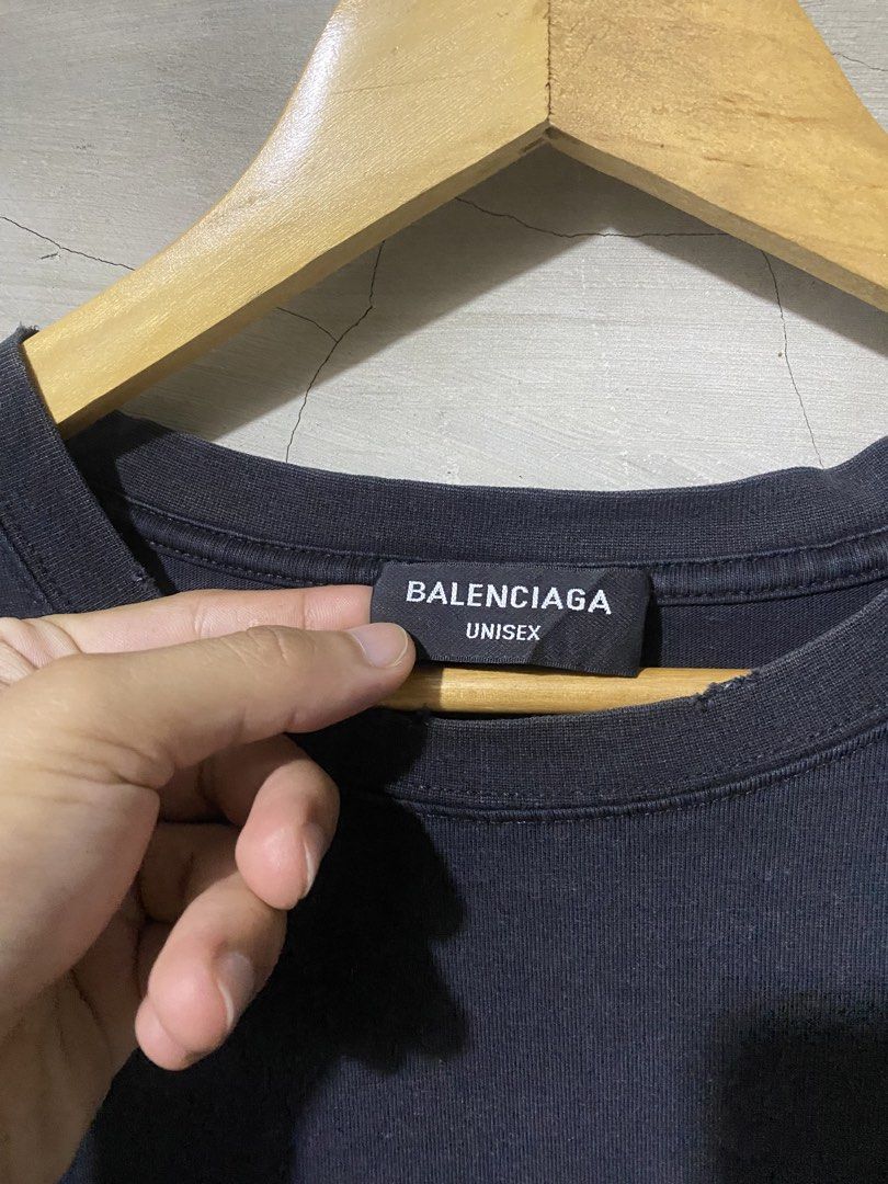 Balenciaga Graffiti Logo Tee Dark Grey Size M (Category: Shirts) located in Manila. Submitted by scapethrift (Listing ID 1466297508, Image 3). Description: - Brand: Balenciaga - Color: Dark grey with vintage washed finish - Design: Iconic graffiti logo across the chest - Size: M (Relaxed fit, unisex) - Details: Distressed neckline, includes inner tags.