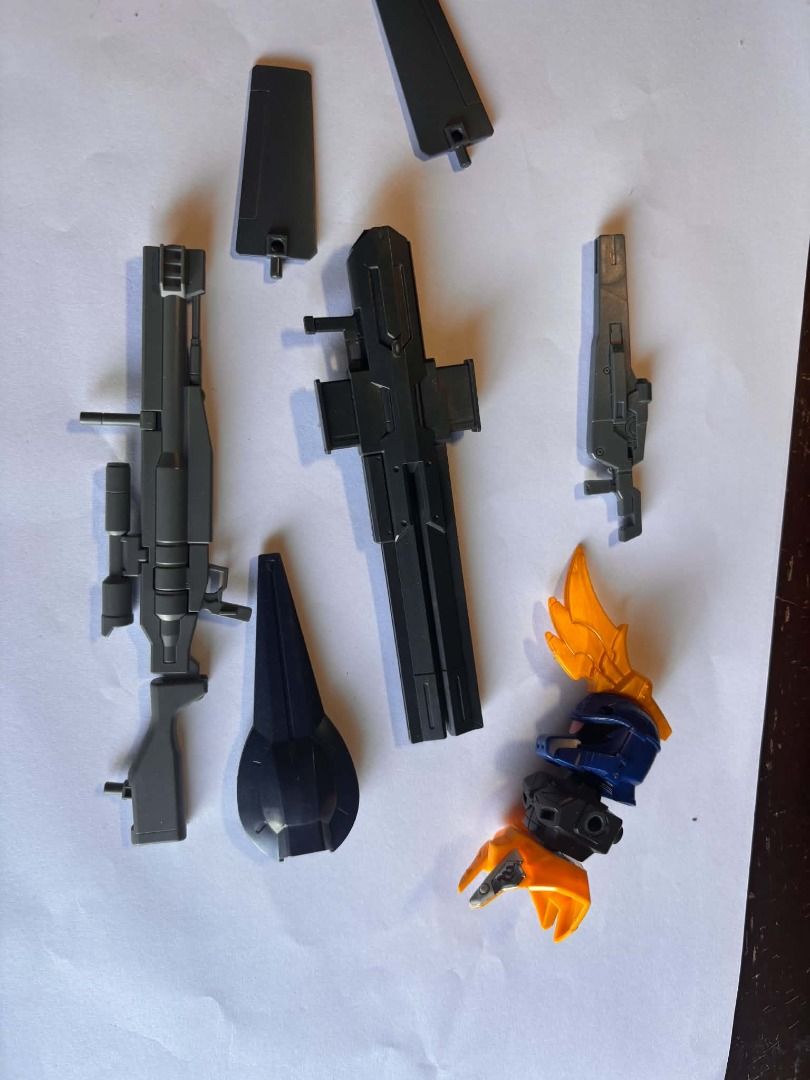 bandai gundam scraps #18 (Category: Gundam & Model Kits) located in Taguig. Submitted by livehorse.8cf1df (Listing ID 1466191113, Image 1). Description: - Lot of loose plastic model parts for custom builds or spare parts - Includes multiple grey weapons (rifles and cannons) - Includes 1 small black shield and 2 grey fins - Partial torso assembly featuring blue and orange armor - Sold exactly as pictured - No original box or instructions included.