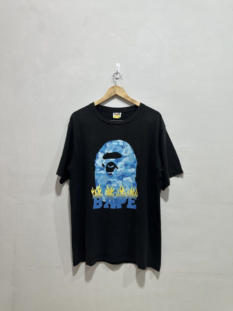 BAPE Ape Head Flame Tee Black Blue XL (Authentic) (Category: Tshirts & Polo Shirts ) located in Manila. Submitted by ylsrarities (Listing ID 1466332027, Image 1). Description: Pre owned with normal signs of wear and age. The black body shows light natural fading and fabric wear. The graphic has some natural print texture and light signs of aging from use. No major holes or tears noted. • Brand: A Bathing Ape / BAPE • Model: Ape Head Flame Tee • D