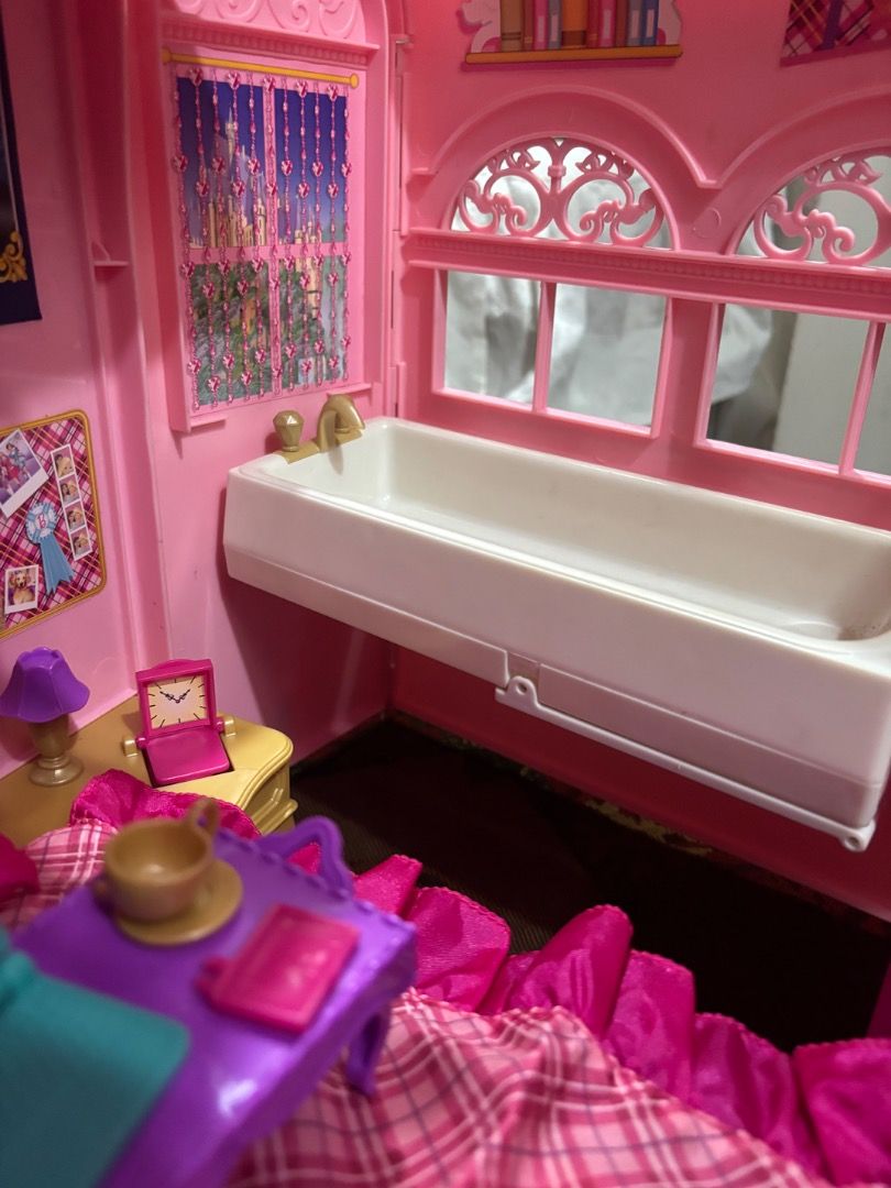 Barbie Princess Charm School Playset (Category: Kids Toys) located in Taguig. Submitted by haenessy (Listing ID 1466325126, Image 3). Description: 2011 Barbie Princess Charm School Playset with the following accessories: - Stairs - Vanity chair - Extra doll outfit - Foldable bed tray - Pillow - Pink and purple sheets - Tea set - Laptop - Curtain clips - Notebooks (2) - Blow dryer - Hairbrush - Toilet Bathtub can be rotated to form another bed. No
