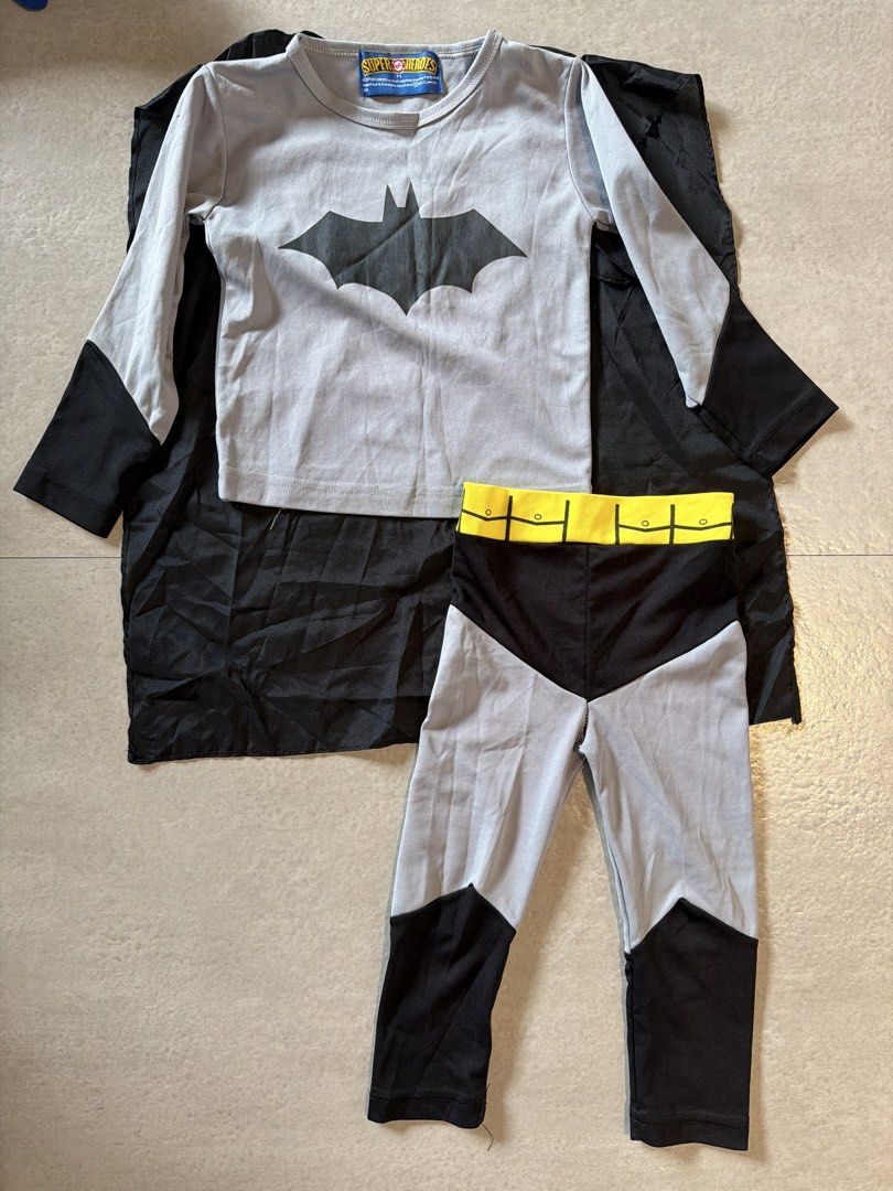 Batman Costume for 2–3yo (Category: Babies & Kids Fashion) located in Las Pinas. Submitted by oliveguns (Listing ID 1466156645, Image 1). Description: - DC Super Heroes Batman costume set - Size: T1 (Toddler) - Long-sleeve grey top with black bat logo with attached black cape - Gartered pants - Issue: pants with obvious stitching on crotch (not seen) .