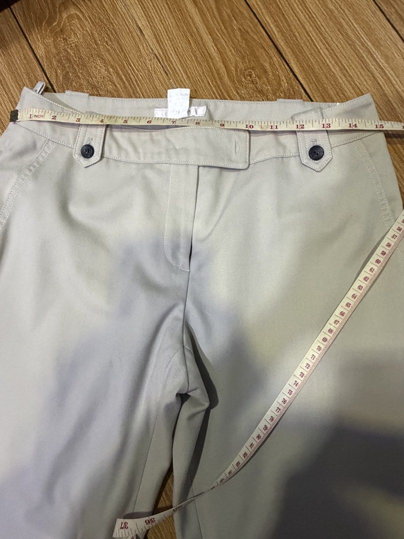Beige trousers with front button details (Category: Jeans) located in San Pedro. Submitted by skirtlotso (Listing ID 1466205350, Image 2). Description: - Color: Versatile neutral beige - Style: Straight-leg trousers, great for work or casual days - Closure: Front zip with two stylish dark buttons on the waistband - Waist: Approx. 15 inches across - Length: Approx. 35 inches total - Condition: Clean fabric, ready to wear.