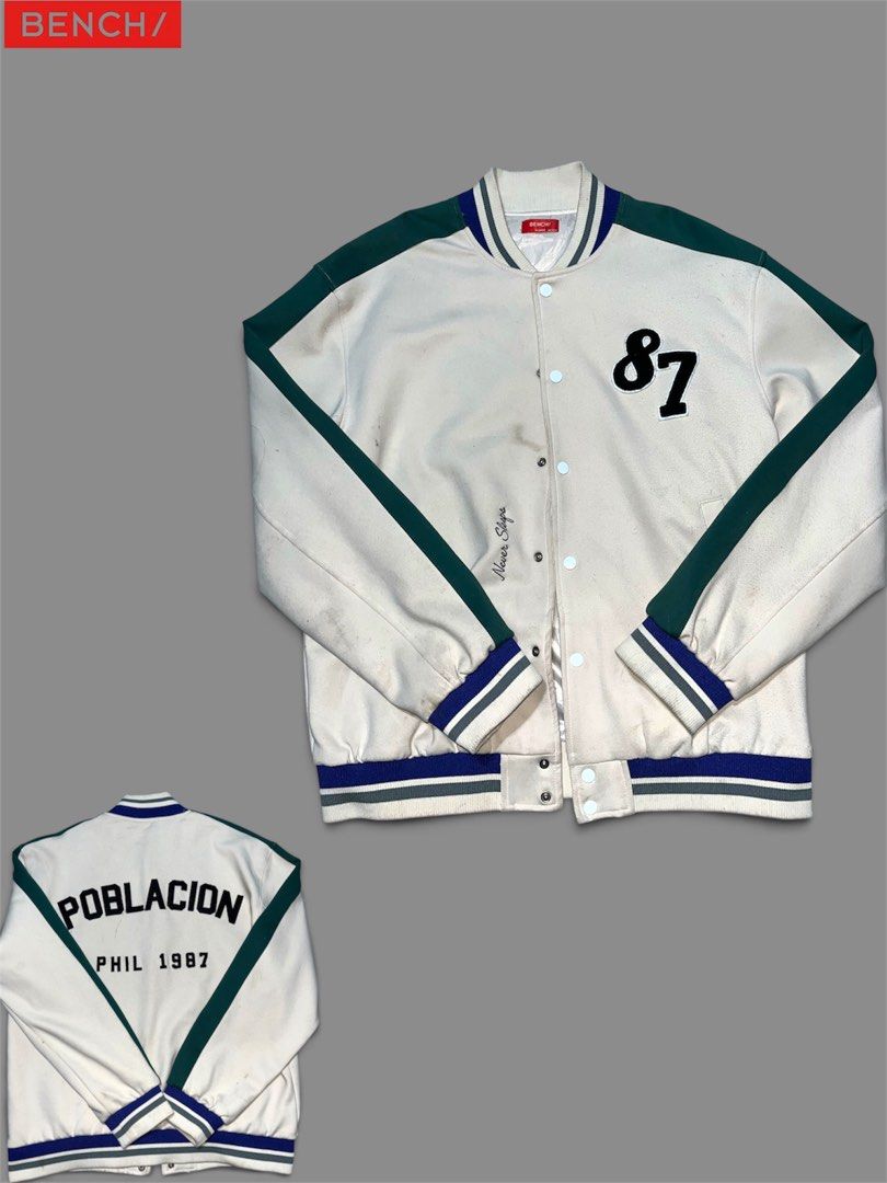 Bench Poblacion Phil 1987 Varsity Jacket White Green (Category: Coats, Jackets and Outerwear) located in Manila. Submitted by laki07 (Listing ID 1466203624, Image 1). Description: - Brand: Bench - Colorway: White, green, and blue - Design: Number 87 patch on chest, 'Poblacion Phil 1987' printed on back shoulders - Closure: Snap button front - Details: Striped ribbed cuffs, collar, and hem - Condition: Pre-loved with visible marks and stains on th