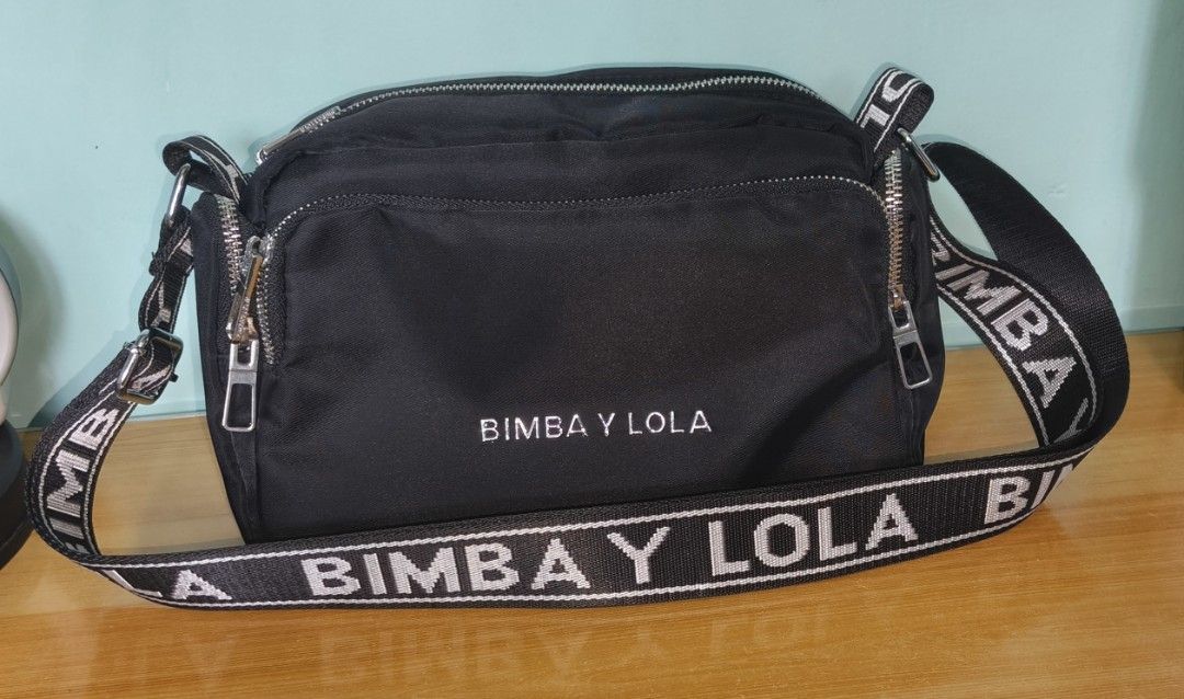 Bimba Y Lola bag nylon (Category: Cross-body Bags) located in Rizal. Submitted by baltiq (Listing ID 1466182440, Image 1). Description: nylon bag Bimba Y Lola ✔classic black with silver hardwares - brand engraved ✔wide shoulder strap, adjustable ✔multiple compartments, all zip closure 📌can pass as b'new, malinis labas at loob 📌bigay lang saken, used twice 💰MOP: GCash.