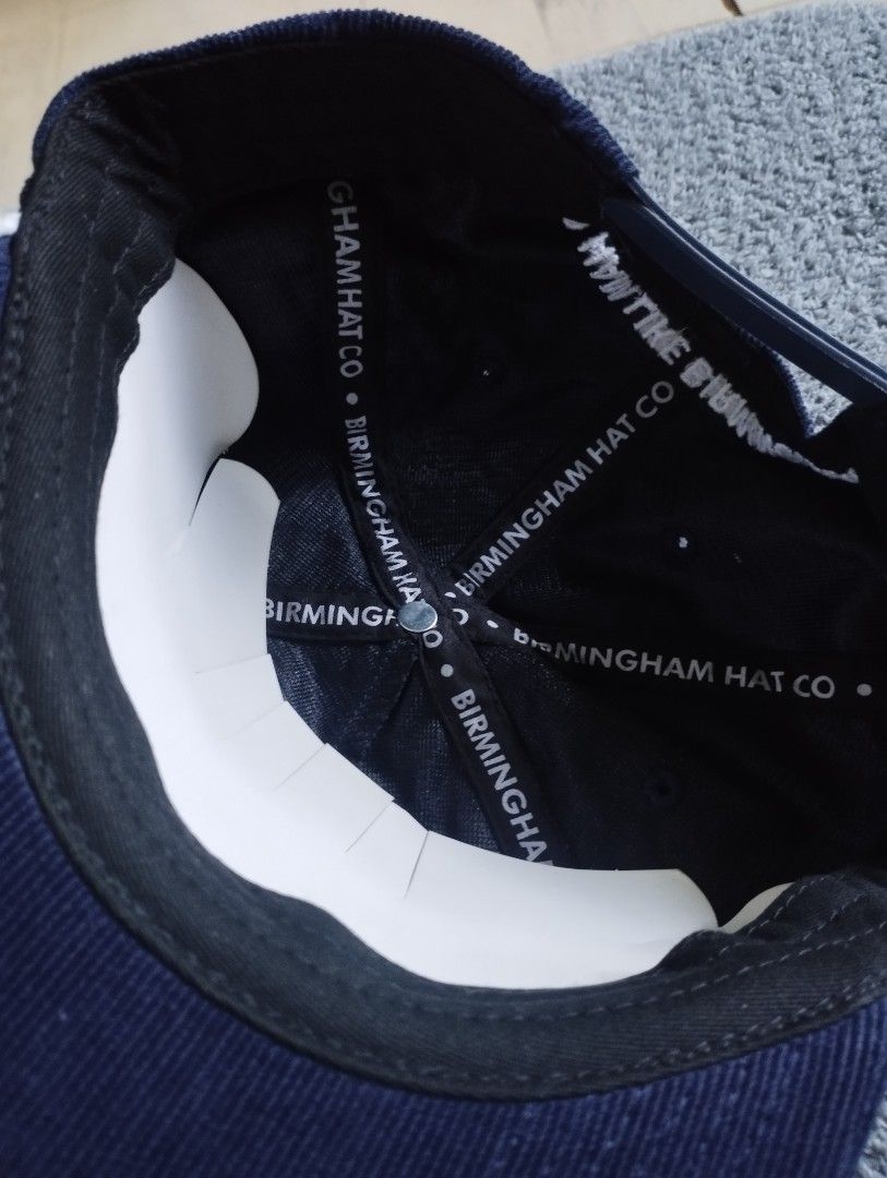 Birmingham Hat Co Navy Corduroy Snapback Hat (Category: Caps & Hats) located in Manila. Submitted by happycaps (Listing ID 1466176308, Image 3). Description: - Brand: Birmingham Hat Co. (Est. 2013) - Color/Material: Navy blue corduroy with a structured crown - Details: White embroidered text on front and back arch - Accents: Unique braided cord across the brim - Interior: Branded logo-printed taped seams - Fit: Adjustable snapback closure (fits m