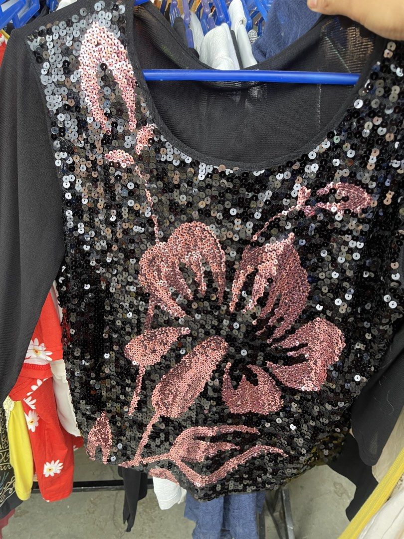 Black and Pink Sequin Floral Pattern Long Sleeve Top (Category: Longsleeves) located in La Trinidad. Submitted by potatothriftlip (Listing ID 1466239130, Image 1). Description: - Color: Black with a giant pink sequin flower - Fabric: Sheer mesh across shoulders and neckline, covered in sparkly sequins - Design: Scoop neck, long sleeves - Occasion: Perfect statement piece for parties, clubs, and nights out - Condition: Excellent.