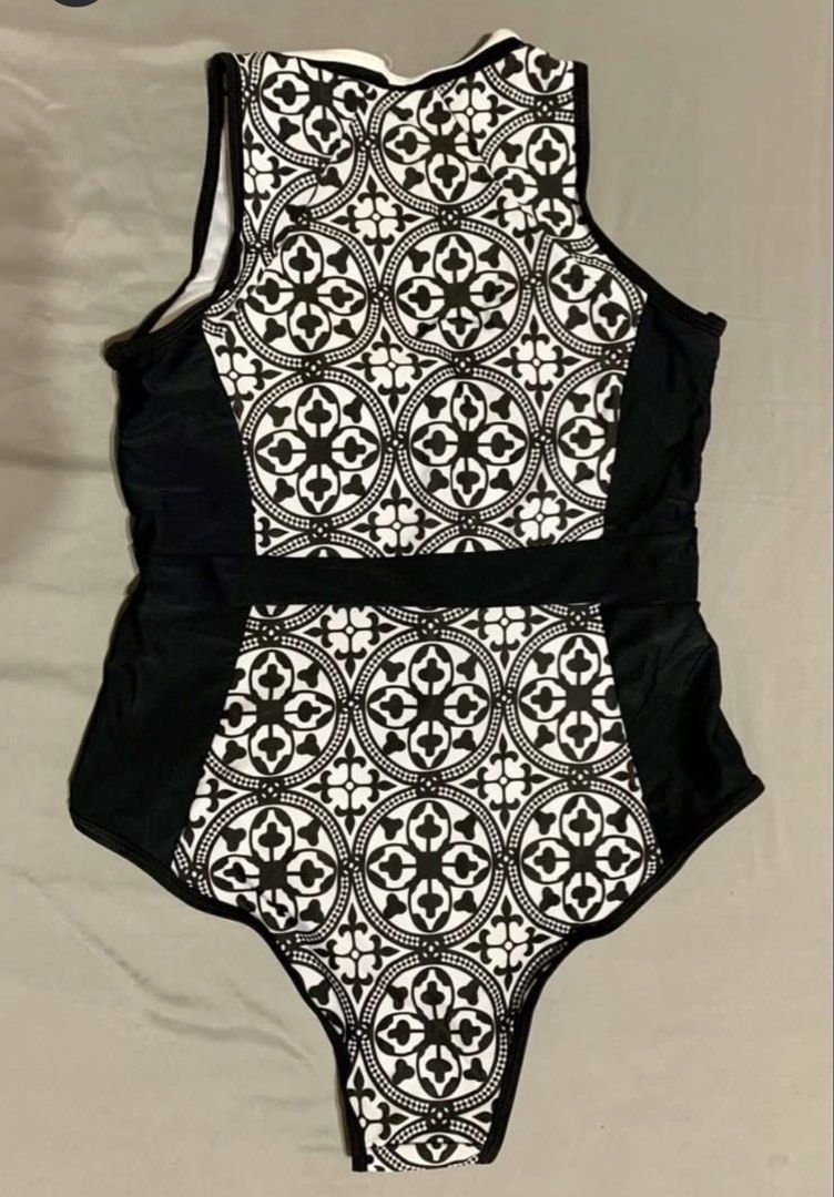 Black and White Patterned One-Piece Swimsuit (Category: Bikinis & Swimsuits) located in Las Pinas. Submitted by piwiealcantara (Listing ID 1466184267, Image 2). Description: - Stylish black and white one-piece swimsuit - Front zipper closure with contrast white trim - Eye-catching geometric tile pattern on center front and back - Solid black side panels create a flattering, slimming silhouette - Sleeveless tank style with a modern high neckline -