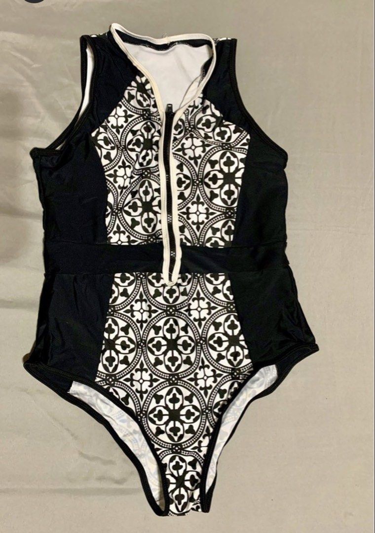 Black and White Patterned One-Piece Swimsuit (Category: Bikinis & Swimsuits) located in Las Pinas. Submitted by piwiealcantara (Listing ID 1466184267, Image 1). Description: - Stylish black and white one-piece swimsuit - Front zipper closure with contrast white trim - Eye-catching geometric tile pattern on center front and back - Solid black side panels create a flattering, slimming silhouette - Sleeveless tank style with a modern high neckline -