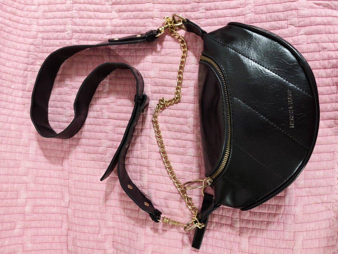 Black crescent shoulder bag with gold chain strap (Category: Cross-body Bags) located in Bulacan. Submitted by gelvy1316 (Listing ID 1466254948, Image 1). Description: - Style: Trendy half-moon shoulder bag in sleek black faux leather - Design: Elegant quilted diagonal stitching on the front with a stylish gold-tone chain accent - Closure & Interior: Secure top zipper opening to a clean, fully lined compartment - Straps & Hardware: Includes a rem