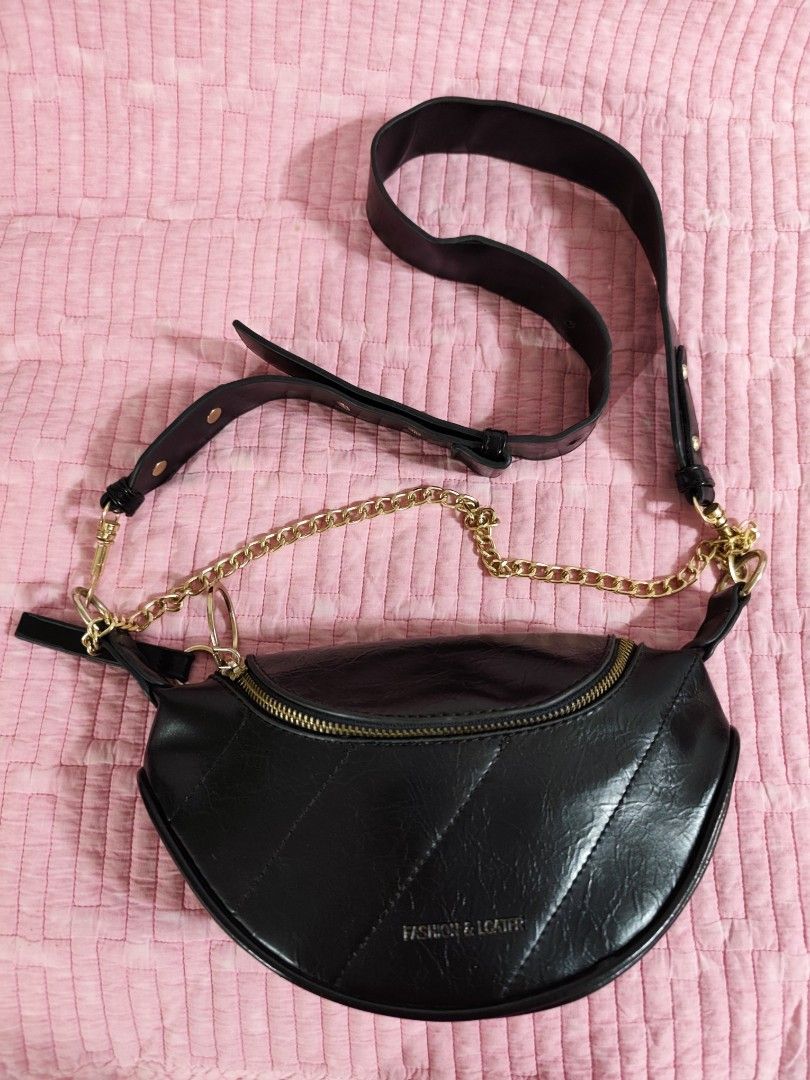 Black crescent shoulder bag with gold chain strap (Category: Cross-body Bags) located in Bulacan. Submitted by gelvy1316 (Listing ID 1466254948, Image 3). Description: - Style: Trendy half-moon shoulder bag in sleek black faux leather - Design: Elegant quilted diagonal stitching on the front with a stylish gold-tone chain accent - Closure & Interior: Secure top zipper opening to a clean, fully lined compartment - Straps & Hardware: Includes a rem