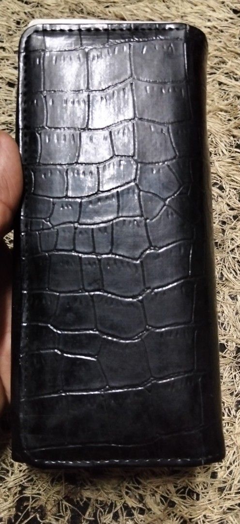 Black crocodile embossed long wallet with multiple card slots (Category: Wallets & Card holders) located in Paranaque City. Submitted by michael-08 (Listing ID 1466190633, Image 1). Description: - Stylish black long wallet with a trendy faux crocodile texture - Secure snap button front flap closure - Spacious interior with multiple card slots and clear ID windows - Includes accordion gusset compartments and a convenient middle zippered pocket - C