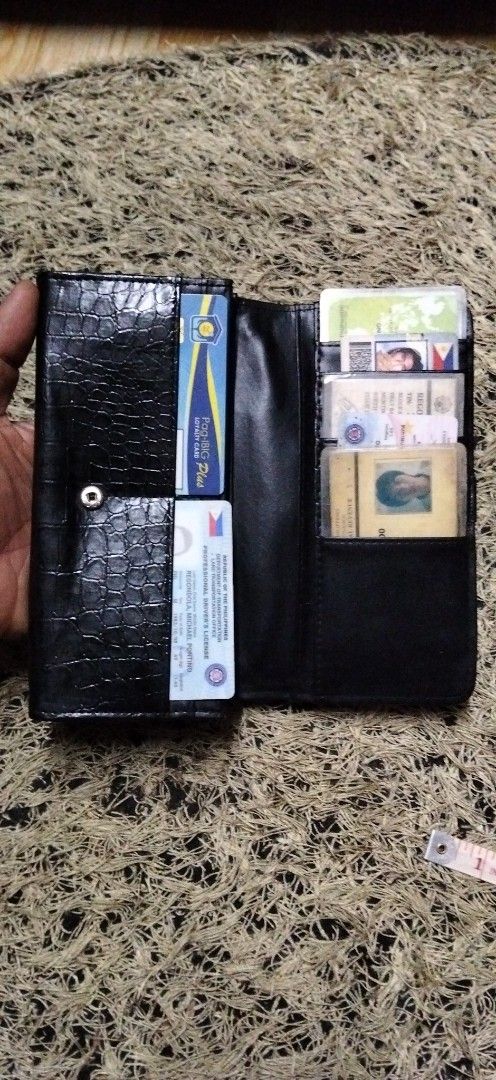 Black crocodile embossed long wallet with multiple card slots (Category: Wallets & Card holders) located in Paranaque City. Submitted by michael-08 (Listing ID 1466190633, Image 2). Description: - Stylish black long wallet with a trendy faux crocodile texture - Secure snap button front flap closure - Spacious interior with multiple card slots and clear ID windows - Includes accordion gusset compartments and a convenient middle zippered pocket - C
