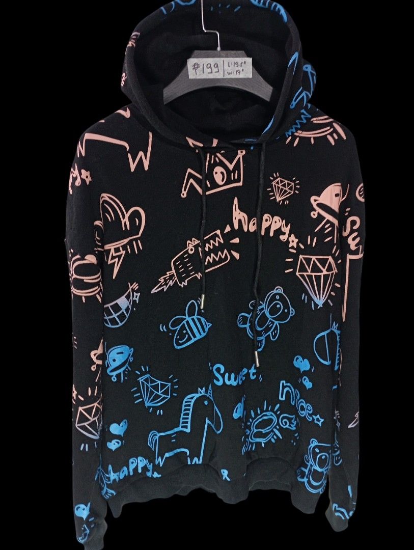 Black Graffiti Print Hoodie Size Large (Category: Hoodies) located in Rodriguez. Submitted by enzo.tv (Listing ID 1466326139, Image 2). Description: Black hoodie covered in colorful doodle prints including unicorns, diamonds, and bears. Drawstring hood and ribbed cuffs. Length measures 19.5 inches, width is 17 inches. Overall good shape, though one print design has some distortion. Comfortable everyday wear with plenty of personality..