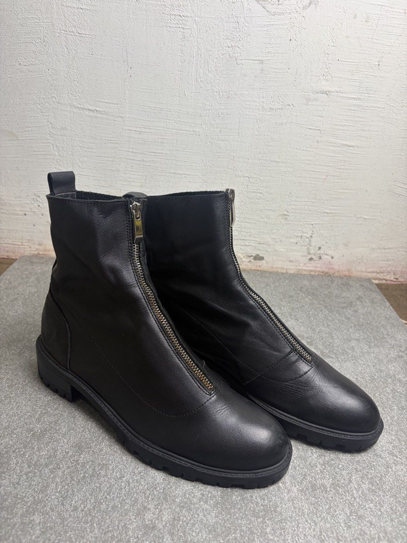 Black leather front zip ankle boots chunky lug sole (Category: Boots) located in Cagayan de Oro. Submitted by taramattsa45690 (Listing ID 1466157766, Image 2). Description: - Style: Minimalist black leather ankle boots - Closure: Convenient front zipper with back pull tabs for easy slip-on wear - Sole: Chunky lug sole for solid, everyday traction - Toe: Classic round toe design - Versatility: Highly versatile and easy to match with different outf