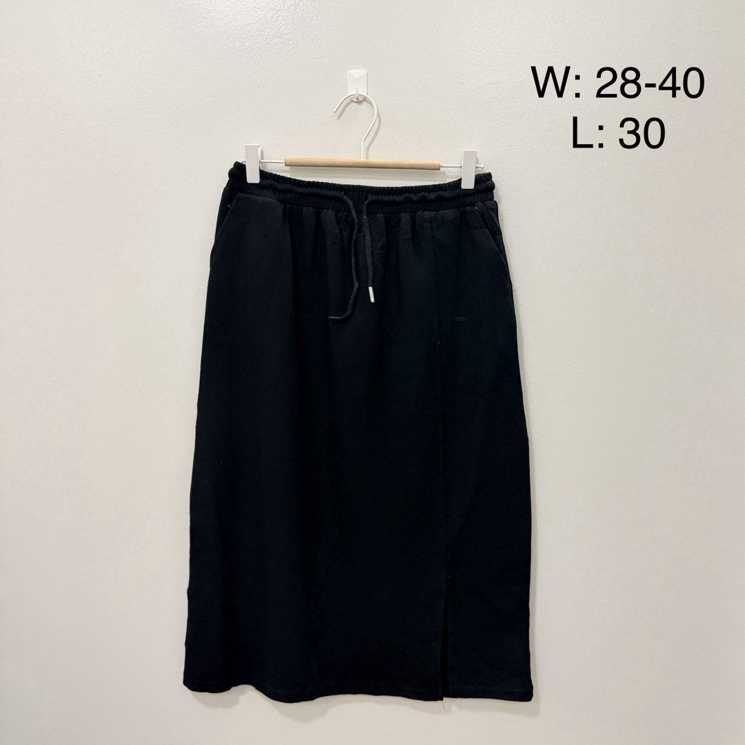 Black Midi Skirt with Drawstring Waist (Category: Skirts) located in Rodriguez. Submitted by jrms23 (Listing ID 1466164273, Image 1). Description: - Color: Classic Black - Length: Midi (30 inches) - Waist: Elastic with drawstring, fits 28" to 40" - Features: Functional side pockets and subtle front hem slit - Material: Soft, comfortable fabric ideal for daily wear - Condition: Brand New.