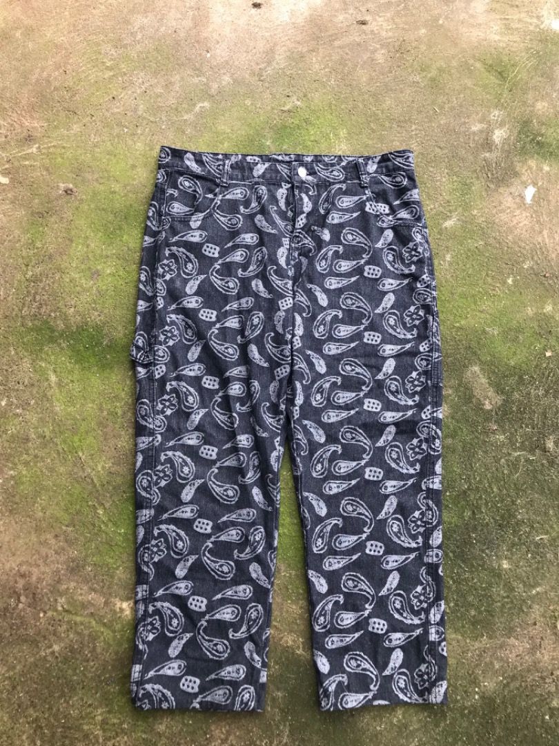 Black Paisley Print Denim Carpenter Pants (Category: Jeans) located in Jimenez. Submitted by onlythrifty_ (Listing ID 1466213286, Image 1). Description: - Color & Pattern: Dark grey with an all-over white paisley print - Fit: Relaxed straight leg for maximum comfort - Material: Heavyweight, durable cotton with crisp print details - Features: Classic carpenter style with functional utility pockets on sides and back - Closure: Button fly Waist- 32 
