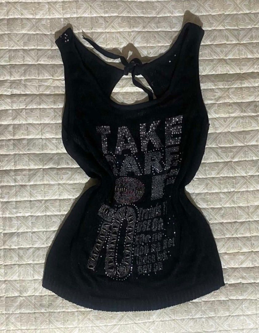 Black Rhinestone Y2K Tank Top (Category: Sleeveless) located in Pagadian. Submitted by kahtlopez47867 (Listing ID 1466278393, Image 1). Description: - Style: Y2K black knit tank top - Details: 'Take Care 70' rhinestone graphics on front - Back Design: Keyhole cutout with adjustable tie strings - Accents: Rhinestones on the straps - Fabric: Soft with slight stretch - Best for: Parties or everyday streetwear.