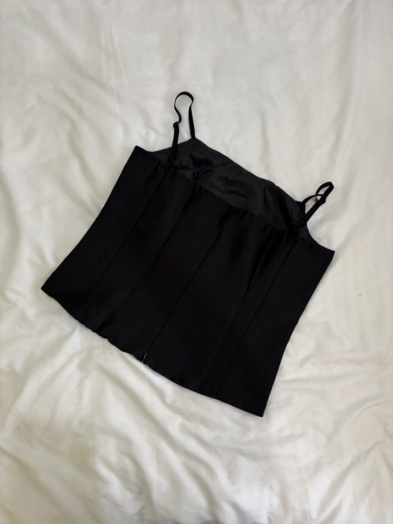 Black Spaghetti Strap Camisole Top (Category: Sleeveless) located in Manila. Submitted by prixo_btg_ (Listing ID 1466239525, Image 2). Description: - Color: Classic Black - Size: Bust 34 - Material: Lightweight satin-like fabric with a subtle sheen - Condition: Excellent / Worn only once.
