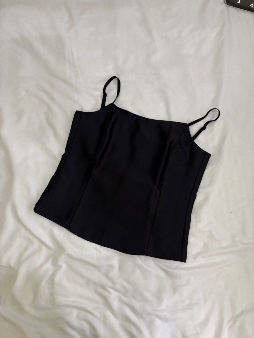 Black Spaghetti Strap Camisole Top (Category: Sleeveless) located in Manila. Submitted by prixo_btg_ (Listing ID 1466239525, Image 1). Description: - Color: Classic Black - Size: Bust 34 - Material: Lightweight satin-like fabric with a subtle sheen - Condition: Excellent / Worn only once.