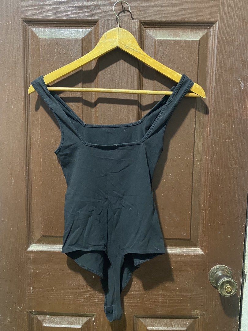 Black square neck bodysuit (Category: Sleeveless) located in Calamba. Submitted by soleilcollections.ph (Listing ID 1466237335, Image 2). Description: - Color: Black - Style: Sleeveless bodysuit with square neckline (front and back) and wide straps - Material: Stretchy, comfortable fabric - Versatility: Easy to pair with jeans, skirts, or shorts for everyday wear.