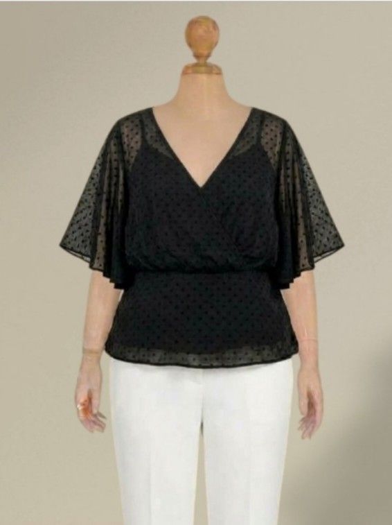 Black Swiss Dot V-Neck Peplum Blouse (Category: Blouses) located in Quezon City. Submitted by dannikkishoppe2 (Listing ID 1466188949, Image 1). Description: Black Swiss Dot V-Neck Peplum Blouse ‼️₱150‼️ Black blouse with sheer Swiss dot fabric and flutter sleeves. V-neck wrap front design. Peplum style with fitted waist and relaxed lower half. Chest measures 22 inches, length is 25 inches..