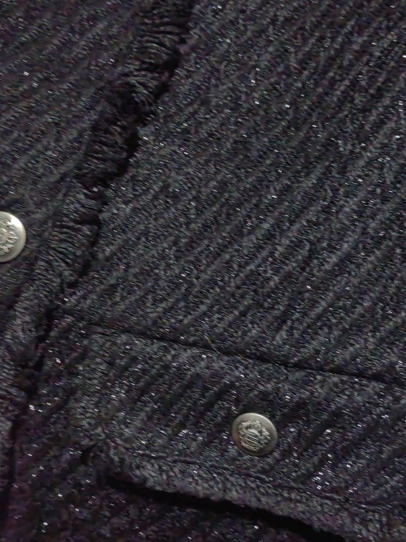Black Tweed Sleeveless blazer (Category: Sleeveless) located in Donsol. Submitted by saksthriftavenuebyluckymaria8 (Listing ID 1466259010, Image 3). Description: - Style: Black tweed sleeveless vest with subtle metallic threading - Details: Fringe trim on neckline, placket, and pockets with ornate silver-tone metal buttons - Features: Fully lined interior, two front functional pockets - Size: Free Size (F) - Material: Polyester and cotton blend -